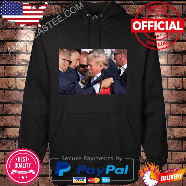 Trump was covered by secret service agents as he was let from the stage shirt