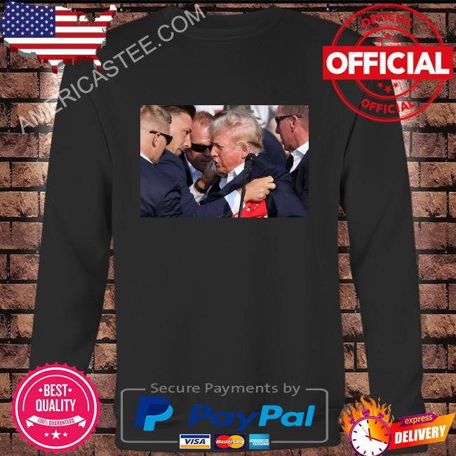 Trump was covered by secret service agents as he was let from the stage shirt