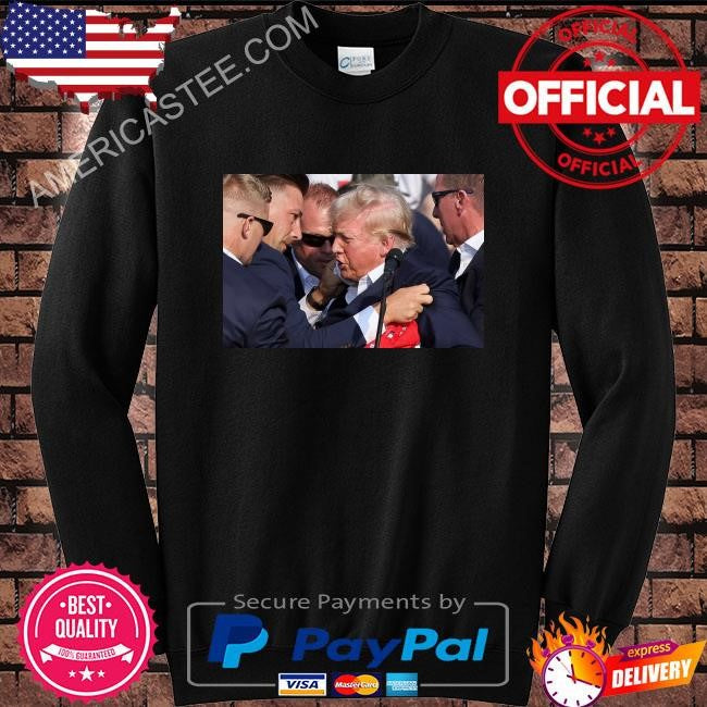 Trump was covered by secret service agents as he was let from the stage shirt