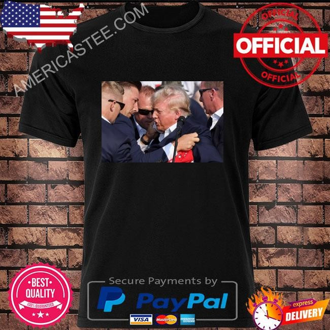 Trump was covered by secret service agents as he was let from the stage shirt