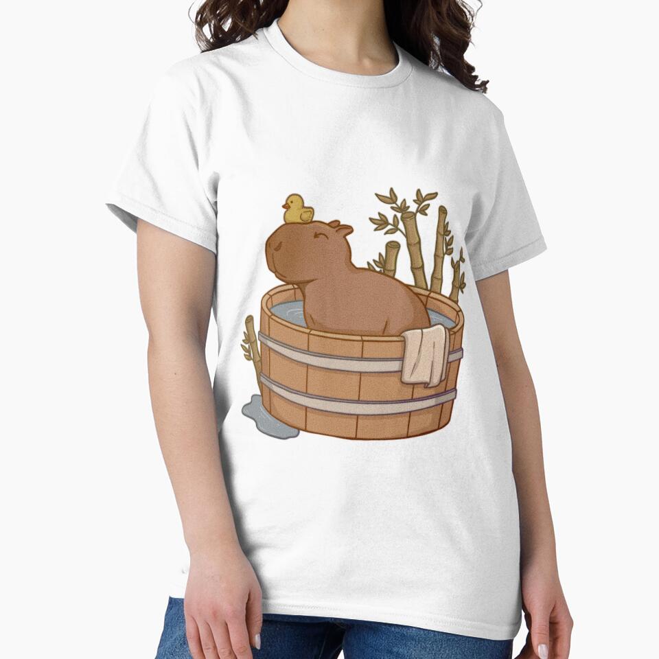 Capybara with rubber duck taking a bath in a wood tub surrounded by bamboo by Bianca Stancu T-Shirts, Hoodie,... (Image 2)