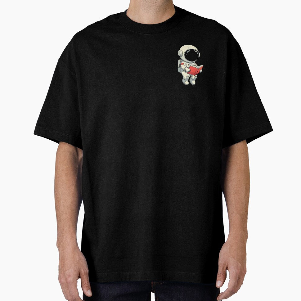 Cute Astronaut Reading a Red Book – Floating Space Explorer Vector Art by PixelVibe782 T-Shirts, Hoodie, Sweatshirt (Image 1)