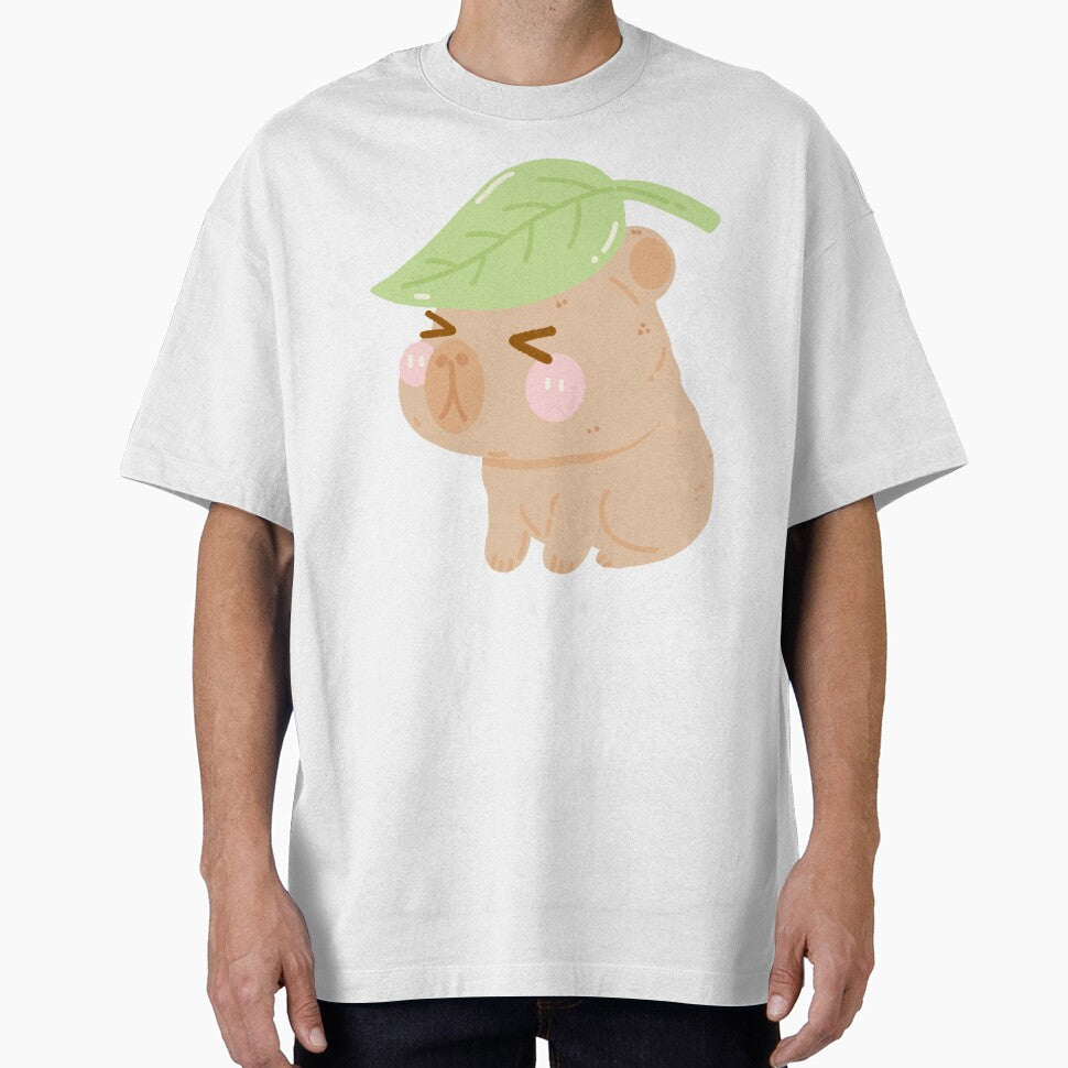 Cozy Capybara Hiding Under a Leaf – Cartoon Style by EmeraldeaArt T-Shirts, Hoodie, Sweatshirt | BlankRebels.com (Image 1)